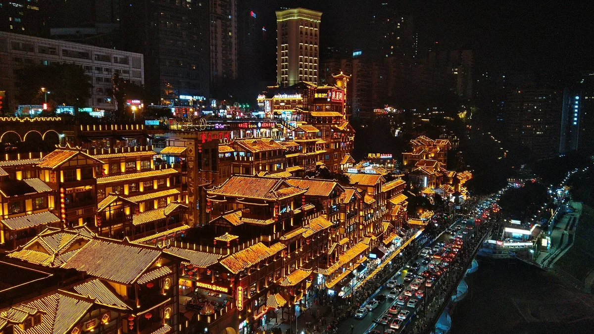 Chongqing Hongya Cave illuminated at night from Qiansimen Bridge
