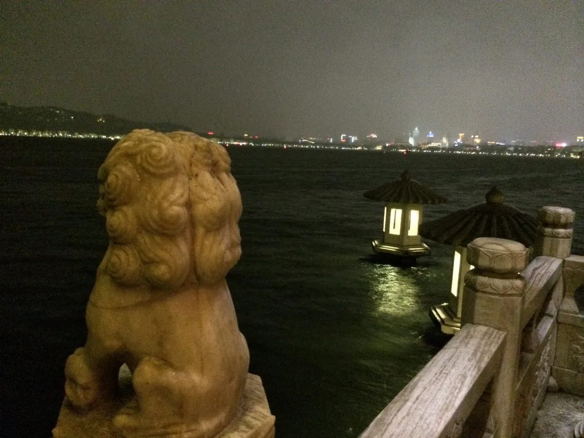 Hangzhou skyline viewed from West Lake at night