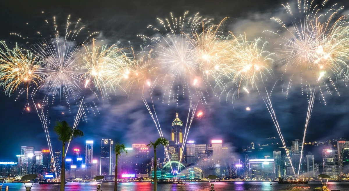 Fireworks and skyline lights over Victoria Harbour in Hong Kong