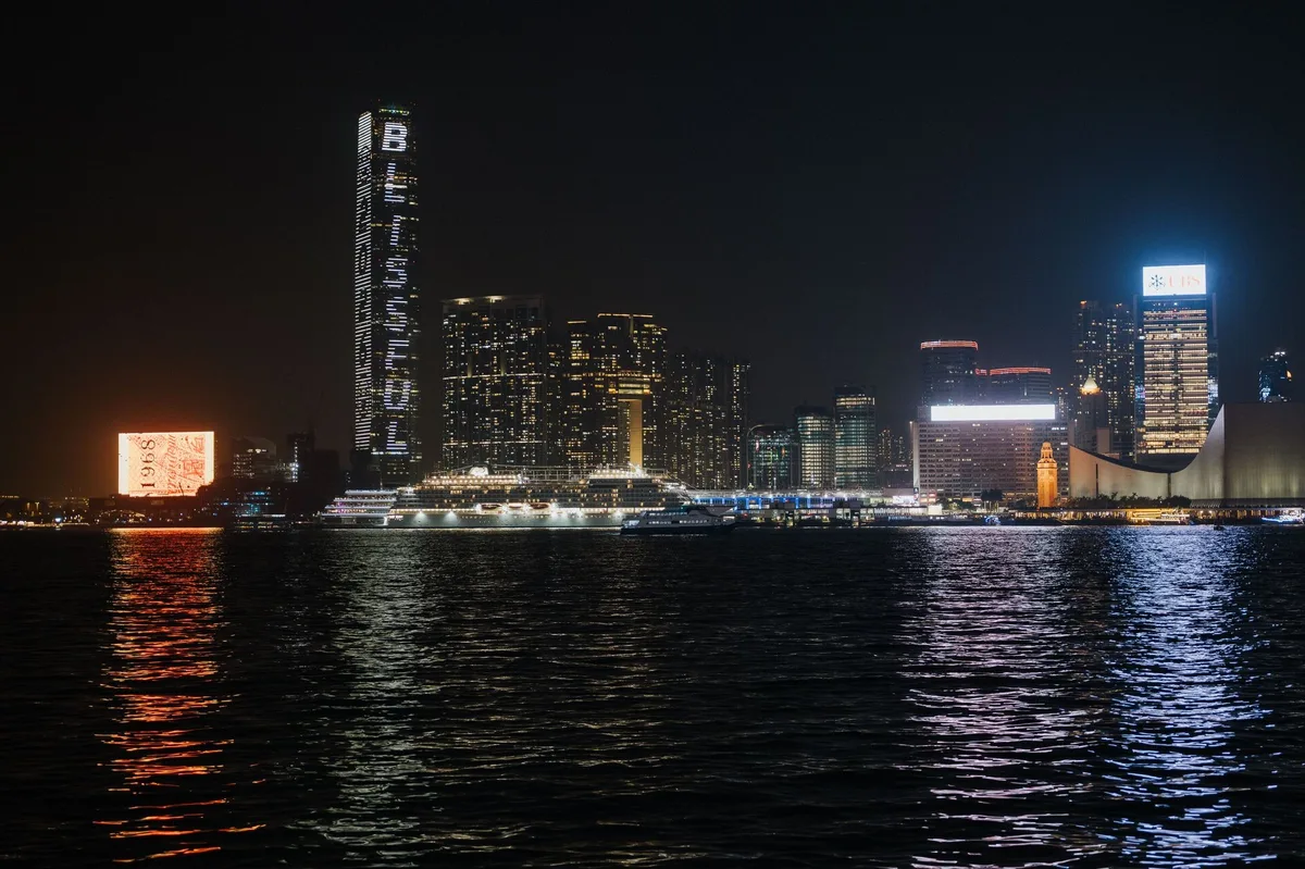 Hong Kong harbour skyline and water reflections at night