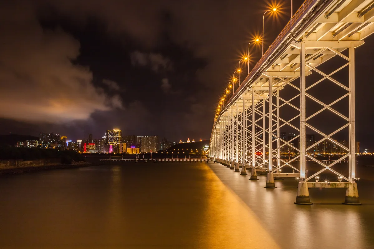 Governor Nobre de Carvalho Bridge and Macau skyline at night