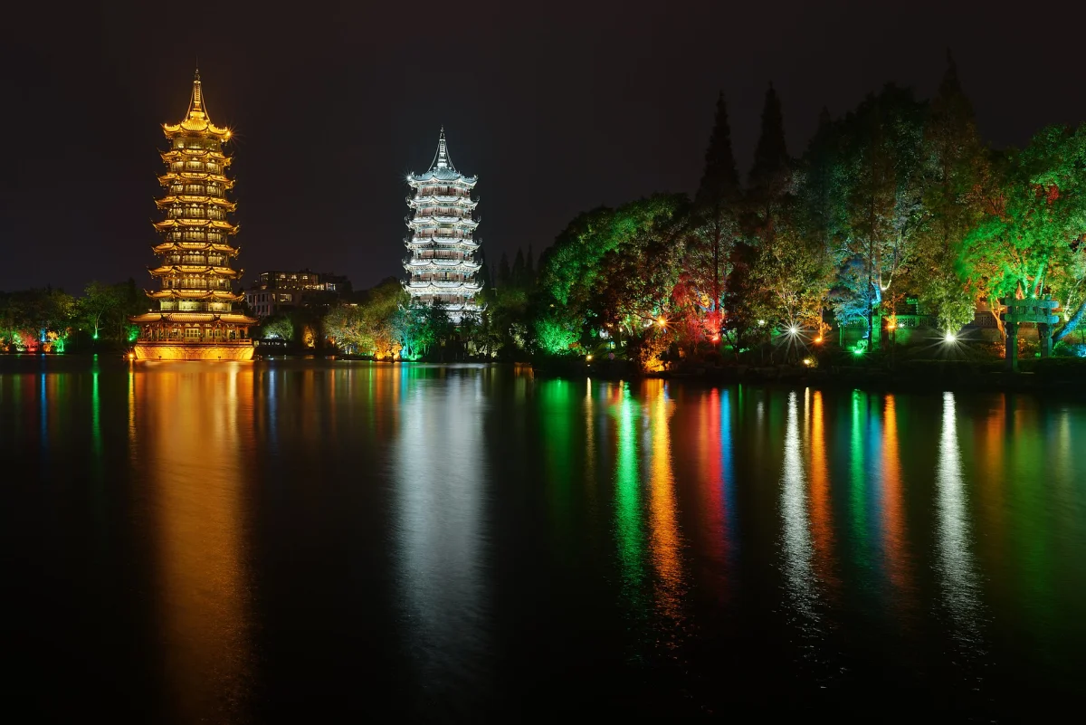 Sun and Moon Pagodas reflected in Shanhu Lake at night in Guilin