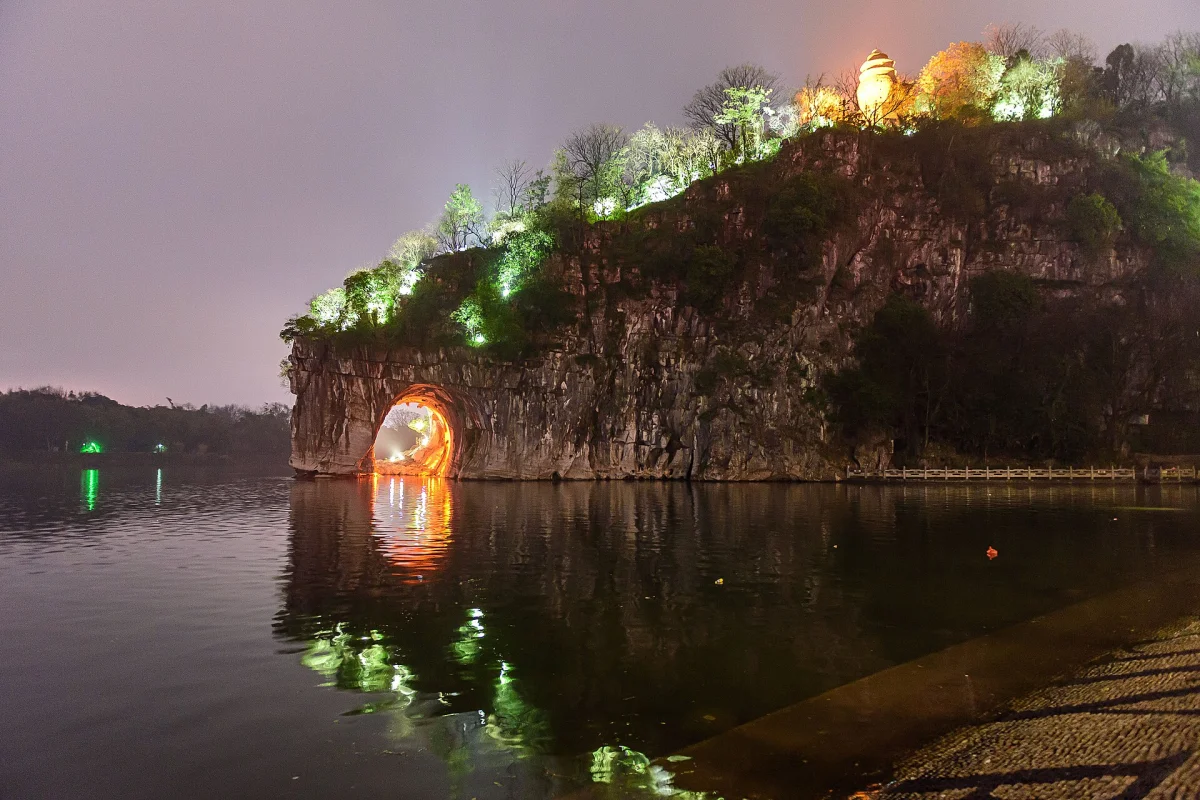 Elephant Hill illuminated at night beside the Li River in Guilin