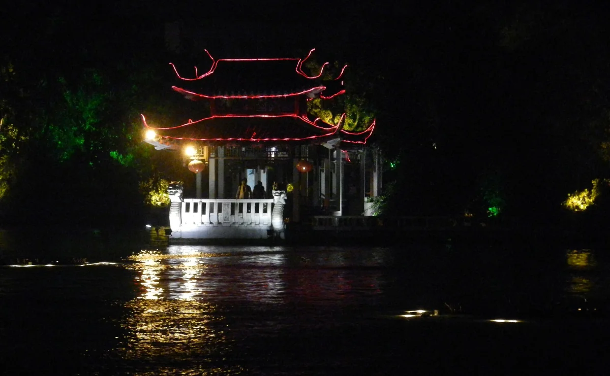 Waterside pavilion lights reflected at night in Guilin