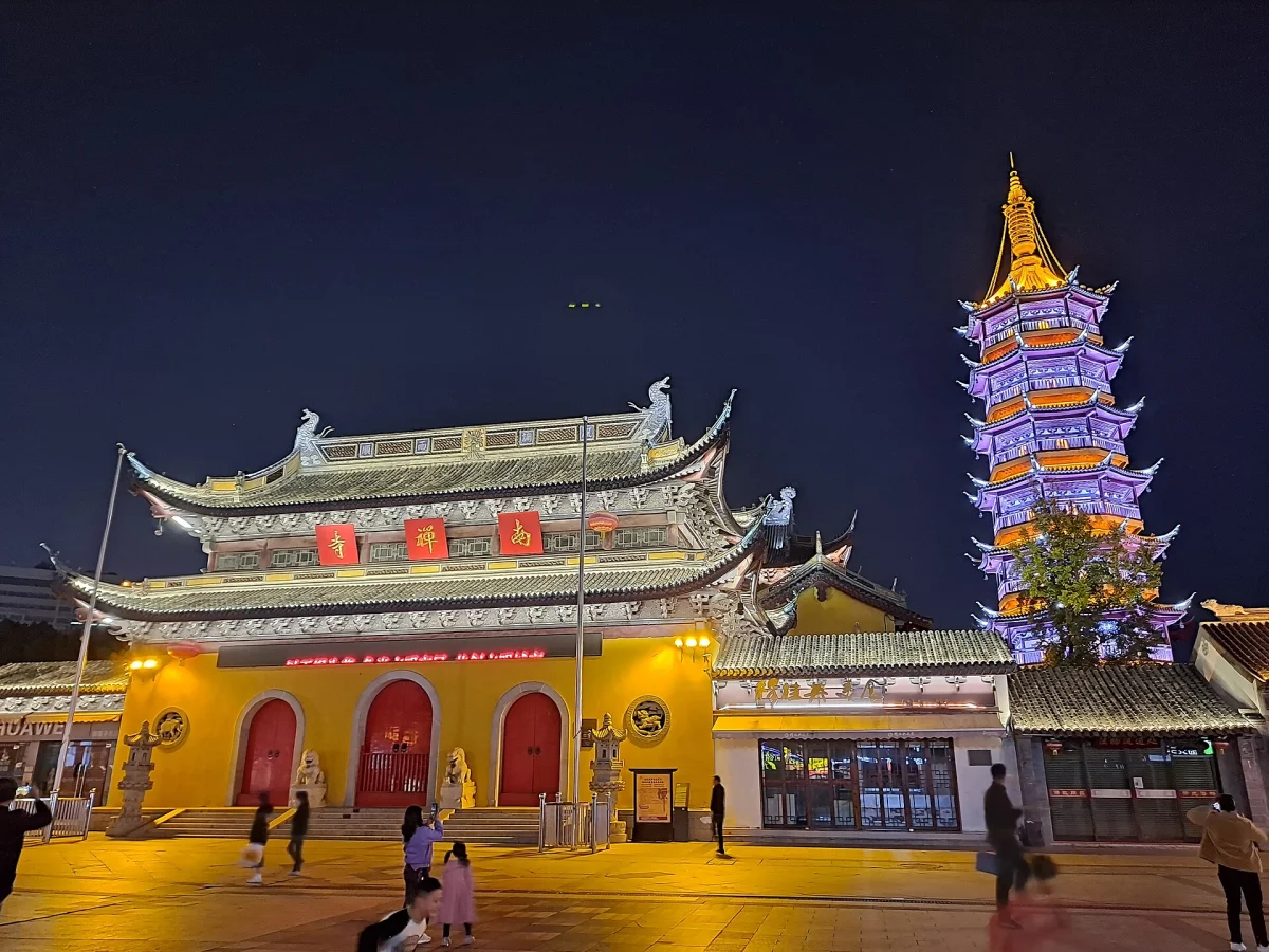 Miaoguang Pagoda and temple buildings at night in Wuxi