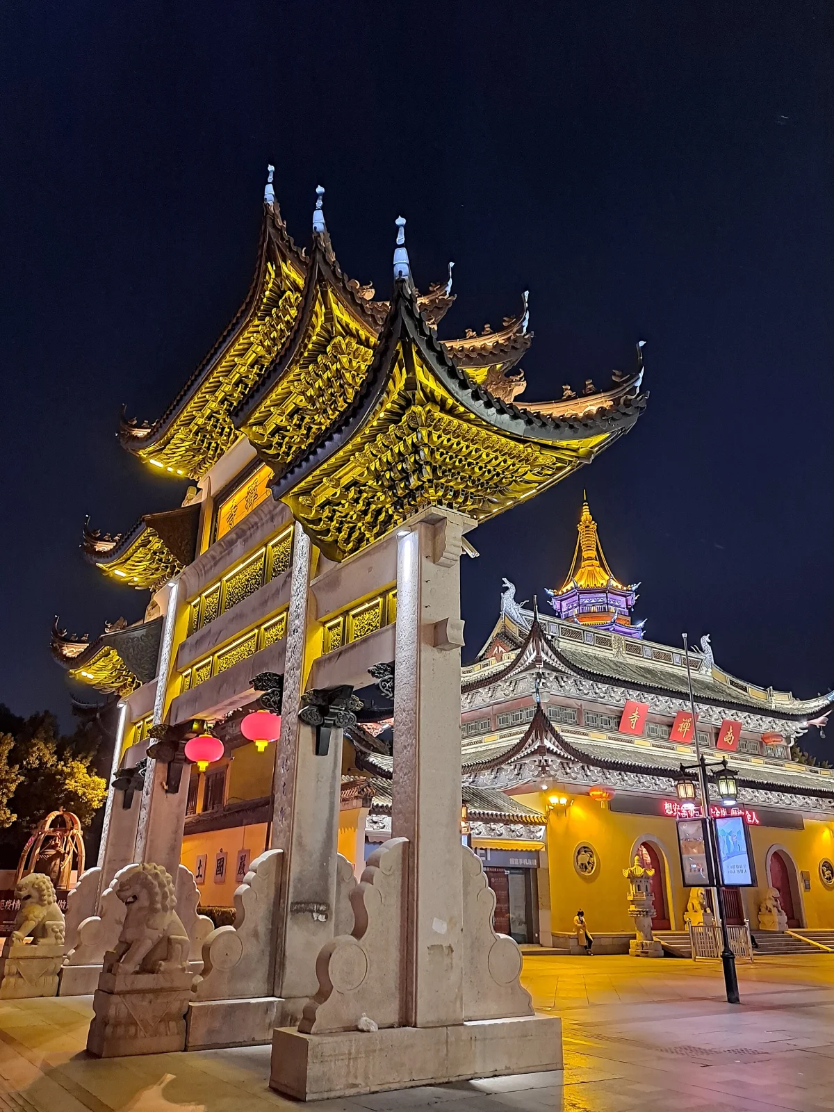 Nanchan Temple gate and lit roofs at night in Wuxi