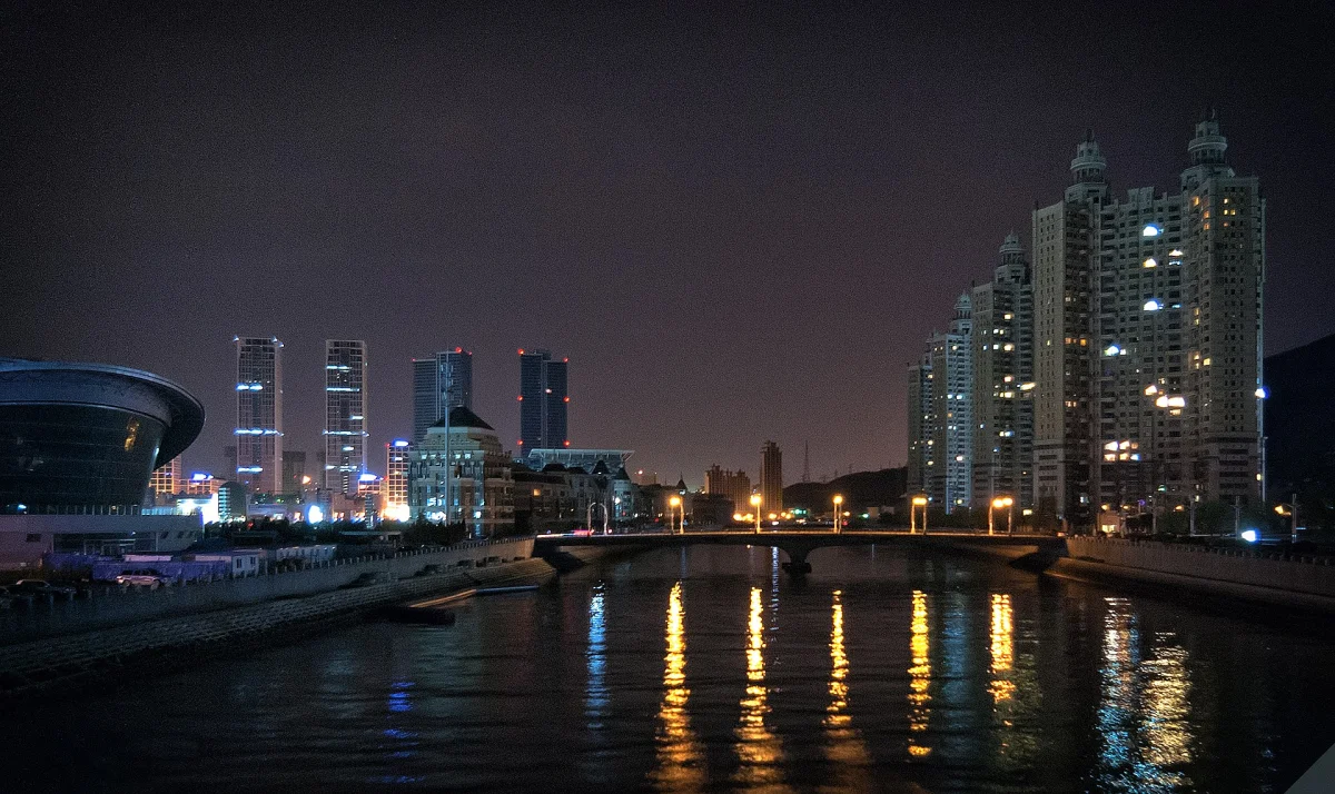 Dalian waterfront skyline reflected on the water at night