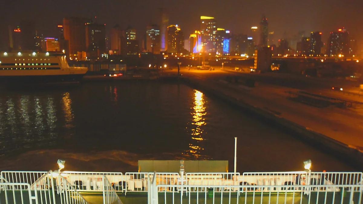 Dalian Port passenger terminal and city skyline lights at night