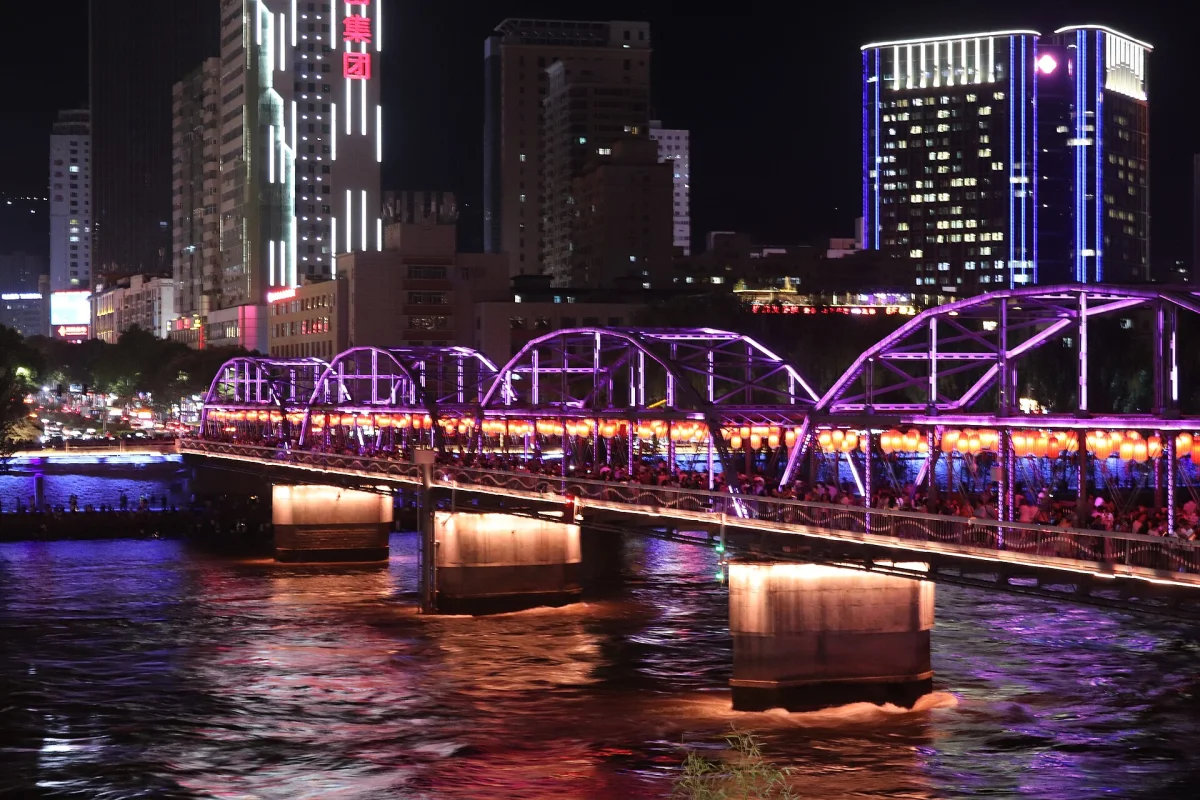 Chengguan District Zhongshan Bridge illuminated with river reflections at night