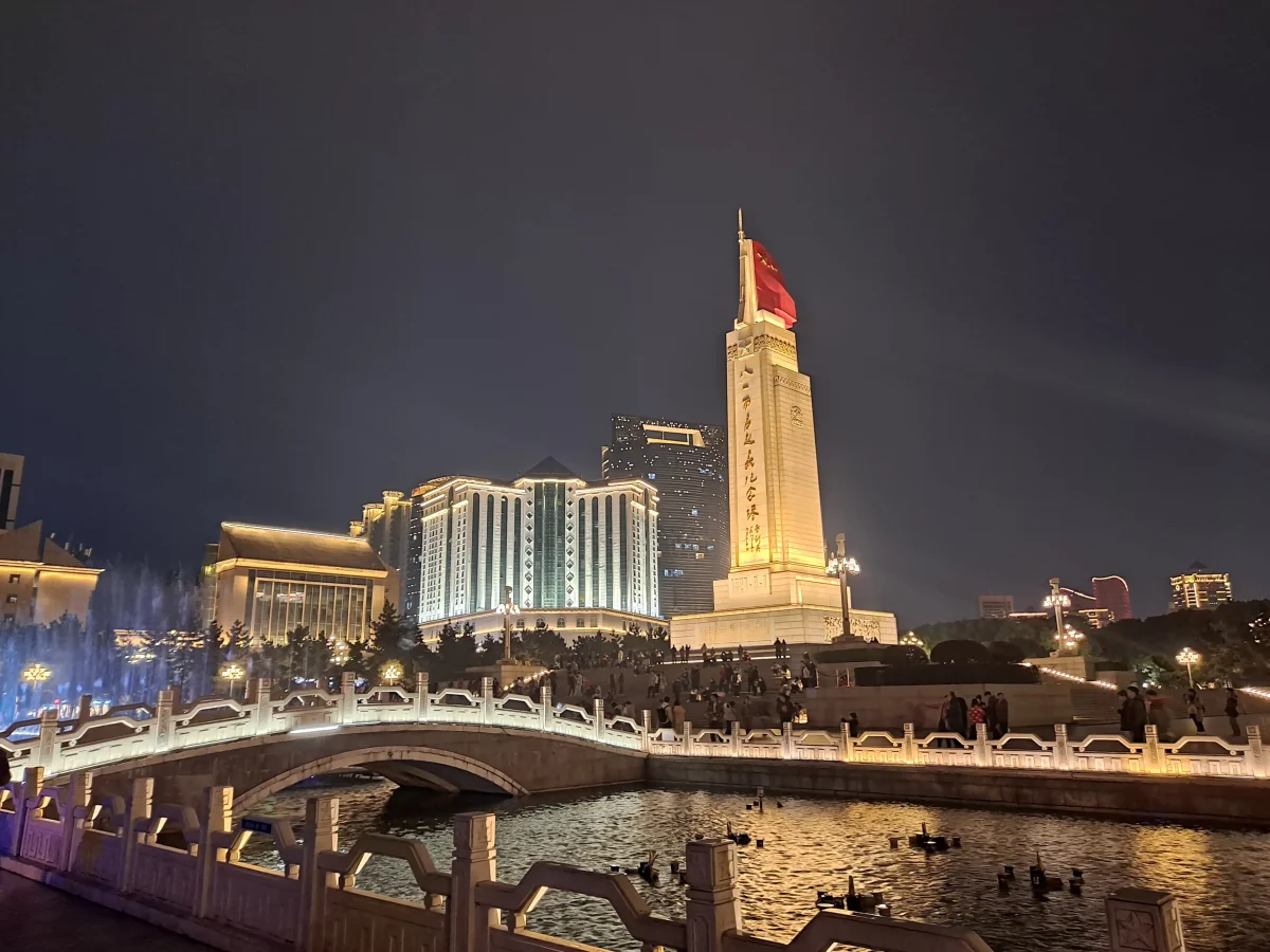 Bayi Square memorial tower area illuminated at night in Nanchang