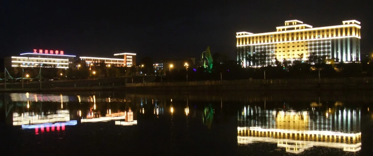 Jinjiang Square buildings reflected on water at night in Changchun
