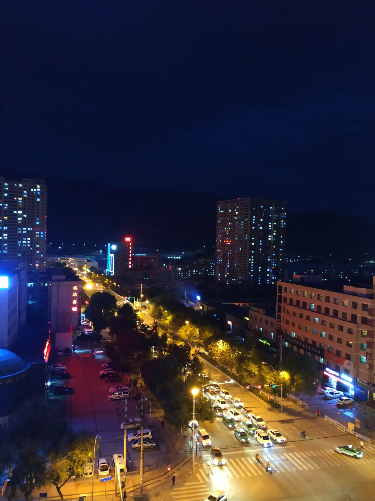 Huangzhong Road traffic and buildings at night in Xining