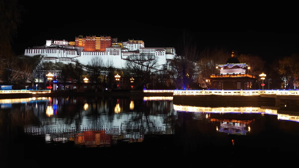 Potala Palace night lights reflected beside the plaza