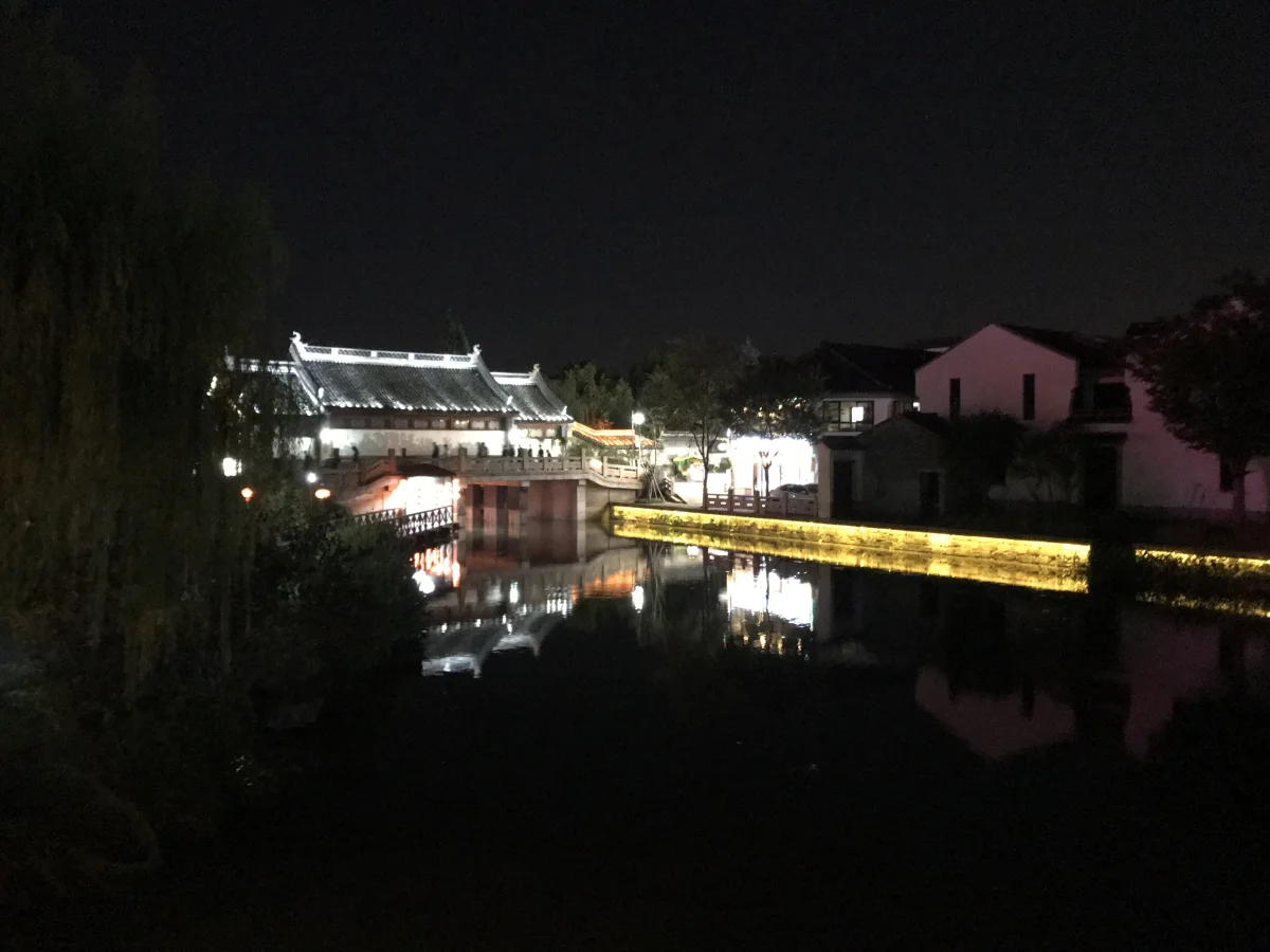 Ancient stage and canal reflections in Xitang at night