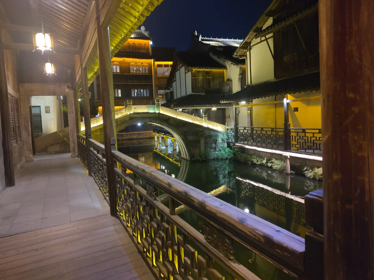 Stone bridge and illuminated houses in Wuzhen at night