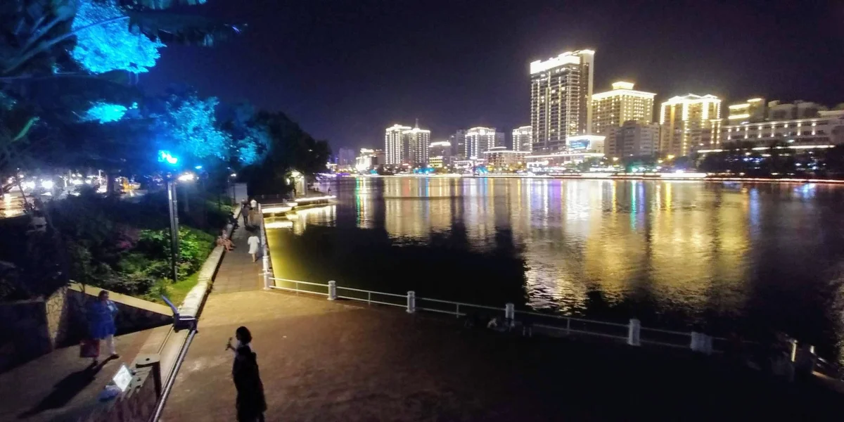 Linchun River waterfront walkway and night reflections in Sanya