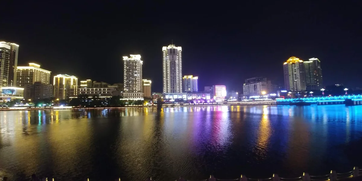 Sanya skyline reflected on the Linchun River after dark