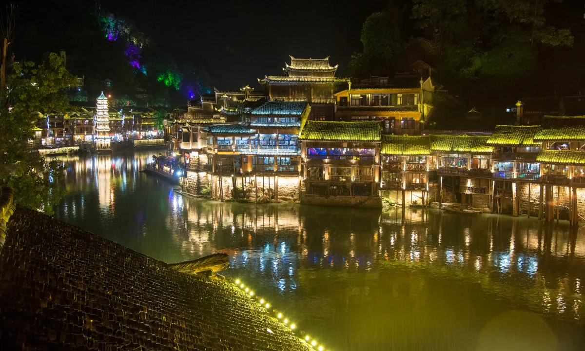 Layered tiled roofs and their reflections across the Tuojiang