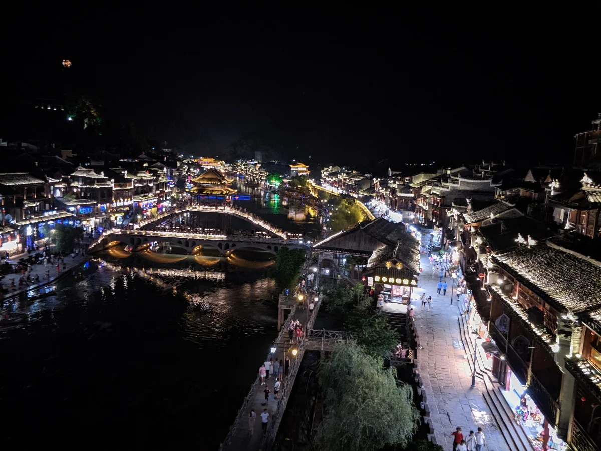 Elevated night view over Fenghuang rooftops and the river