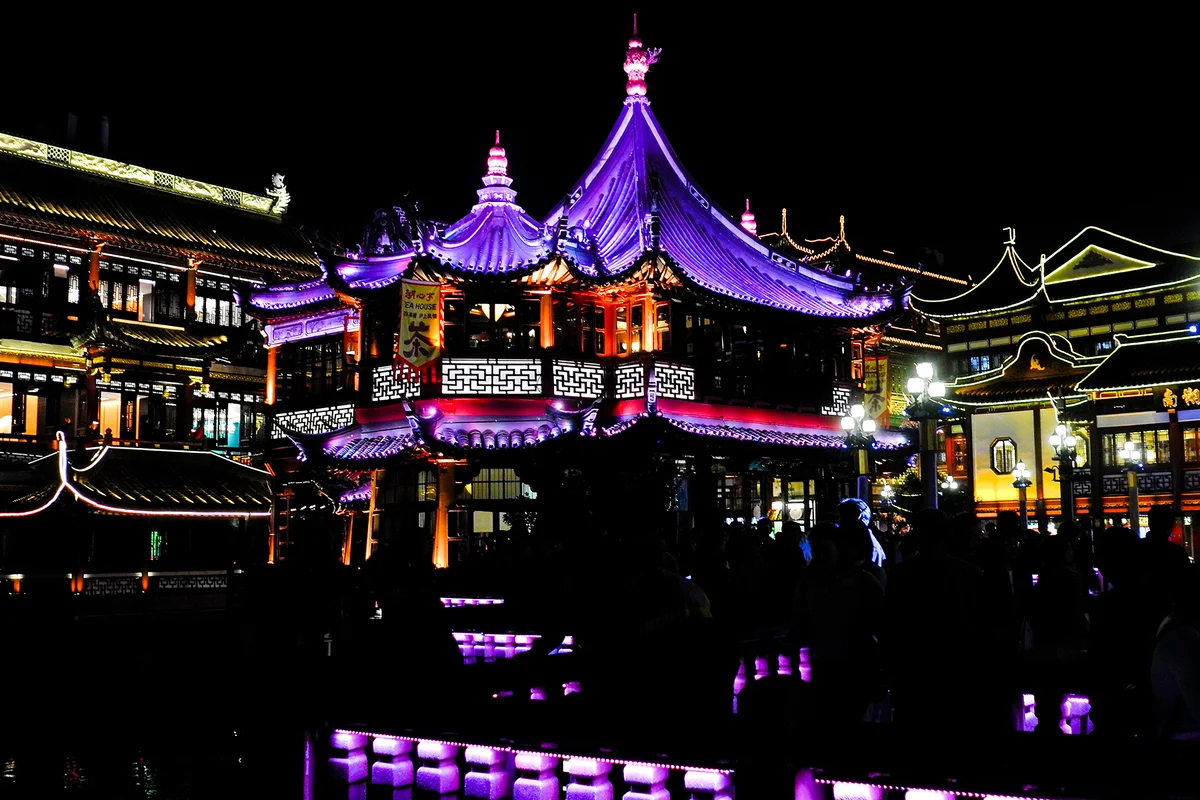 Huxin Pavilion with colored lighting reflected in the pond in October 2019