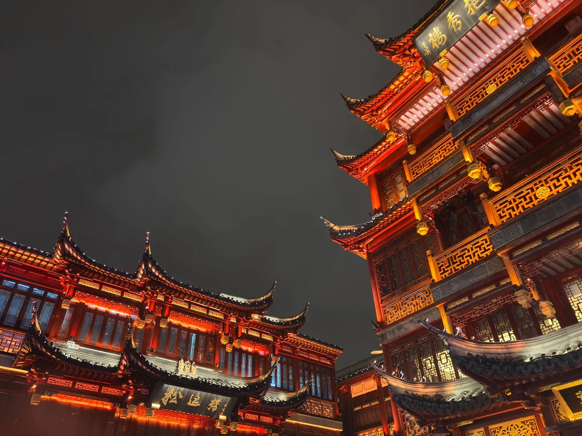 Upturned eaves and illuminated architectural details in Yuyuan Bazaar